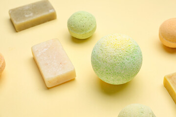 Bath bombs with soap bars on beige background, closeup