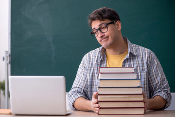 Young male student preparing for exams in the classroom