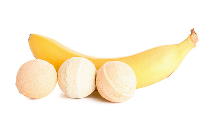Bath bombs with banana on white background