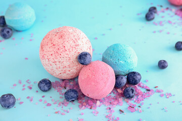 Bath bomb with blueberry and sea salt on light blue background