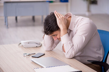 Young male employee working in the office