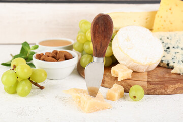 Knife with piece of tasty cheese on table