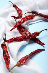 Composition with dry hot chili peppers on blue background