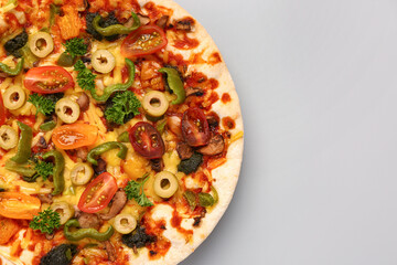 Vegetable pizza on grey background