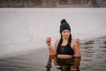 A woman is swimming in cold water during winter, winter cold water swims, healthy lifestyle
