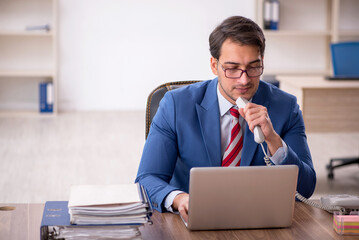 Young male employee working in the office