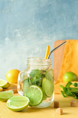 Mason jar of tasty mojito on table