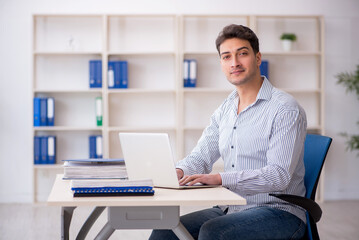 Young male employee working in the office