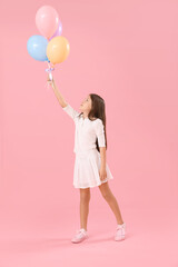 Little girl with balloons on pink background. Children's Day celebration © Pixel-Shot