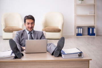 Young male employee working in the office