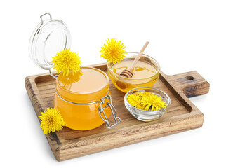 Board with jar and bowl of dandelion honey on white background