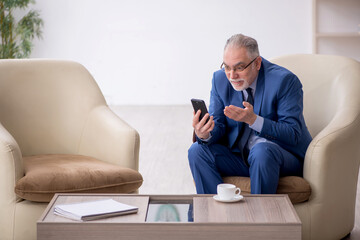 Old businessman waiting for business meeting