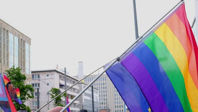 eu national flag on satin, LGBT rainbow flag, Pride flag, participants international LGBT movement, concept of eternal values, global world, Gay pride parade in city, mass march of lesbian, gay people