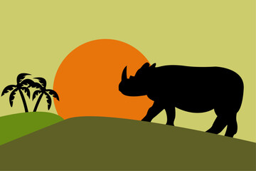 The silhouette of a rhinoceros against the background of sunset or dawn. African rhinoceros or Asian rhinoceros.