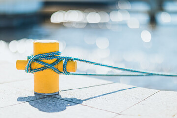 Yellow mooring poler with the ship's mooring tied up