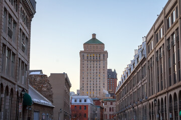 Fototapeta premium Royal Bank tower seen from a street of Old Montreal at sunset, Quebec, Canada