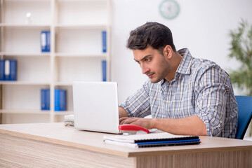 Young male employee working in the office