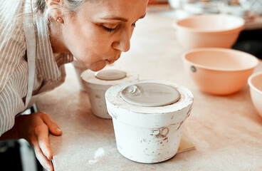 I need these to dry quickly. a female artisan working in her pottery workshop.