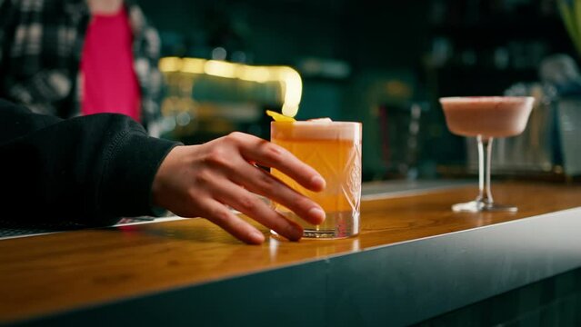 Close-up of guests of the bar holding ready-made delicious alcoholic cocktails in their hands the concept of recreation