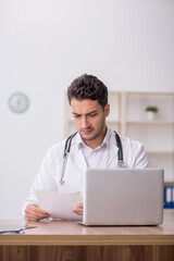 Young male doctor in telemedicine concept