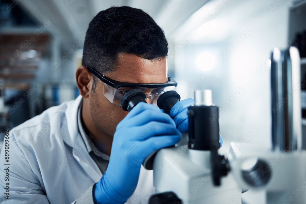 Poster You can run but you cant hide. a young scientist using a microscope in a laboratory.