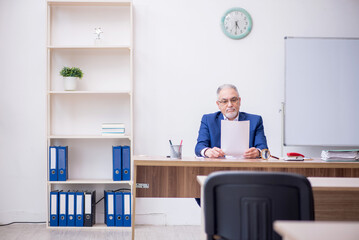 Old male teacher in the classroom