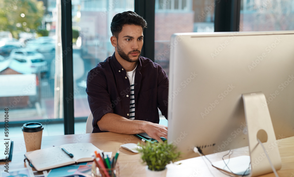 Sticker an entrepreneurs job is never done. a handsome young businessman sitting alone in the office and wor