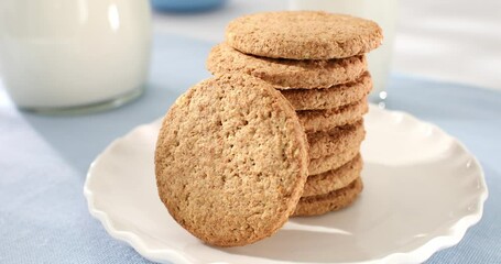 oatmeal cookies with milk close-up. whole grain product. healthy breakfast on a sunny morning. pastries on a blue table. sweets on a plate with corn flakes. Generative AI