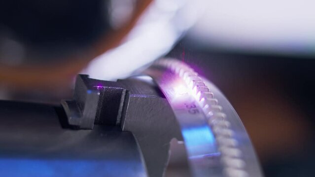 Modern CNC laser engraving machine cutting numbers on metal workpiece for cinema lens. Process of cinema lenses production. Manufacturing and professional industrial equipment concept. Generative AI