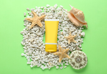 Suntan cream tube, seashells and white marble pebbles on light green background, flat lay