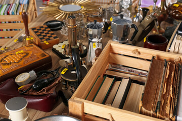 Many different items on wooden table. Garage sale