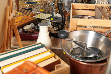 Many different items on wooden table. Garage sale