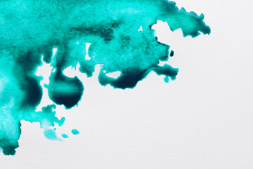 Blot of turquoise ink on white background, top view. Space for text