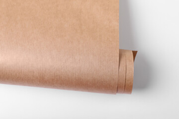 Roll of wrapping paper on white background, top view