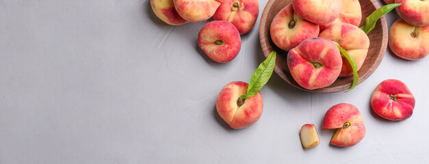 Fresh flat peaches on light table, top view. Banner design with space for text