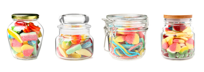 Set of jars with tasty candies on white background