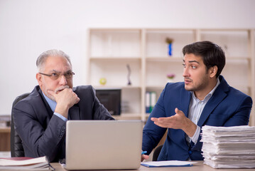 Two male colleagues working in the office