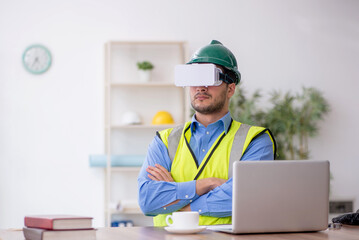 Young male architect wearing virtual glasses
