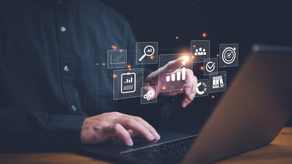 Analyst working with computer in Business Analytics and Data Management System to make report with KPI and metrics connected to database. Corporate strategy for finance, operations, sales, marketing..