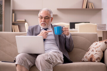 Old male employee working from home during pandemic