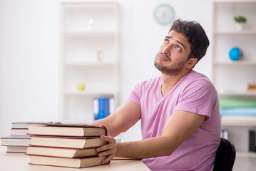 Fototapeta premium Young male student sitting in the classroom