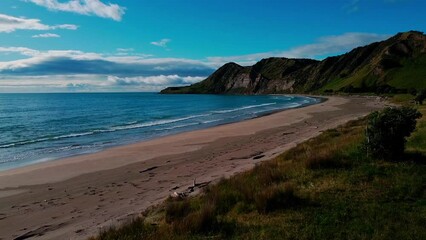 Kaiaua Bay drone shot of beach and cliff.