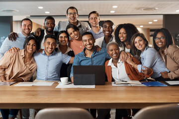 Our deadlines may be tight but our team is tighter. a group of young businesspeople using a laptop...