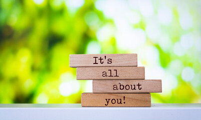 Wooden blocks with words 'It's all about you'.