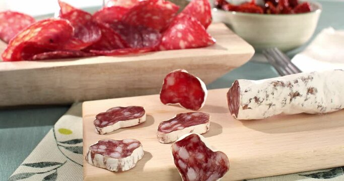 slices sausage salchichon on a plate. salami on a cutting board. cold cuts with bread and tomatoes. traditional spanish and italian sausages. meat delicacies antipasto on the table. Generative AI