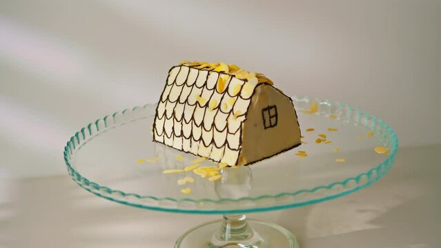 delicious freshly made cherry cake or monastery hut decorated with almond shavings on a stand on a white background