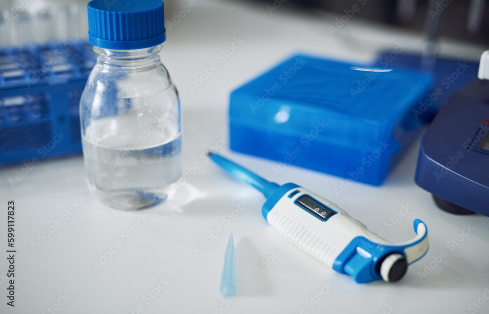 Poster another day, another medical marvel on its way. various scientific testing tools on a table in a lab