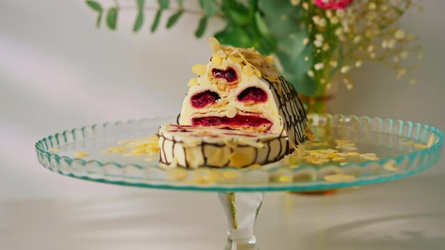 a delicious cherry cake or a monastery hut decorated with almond shavings on a stand cut off a piece