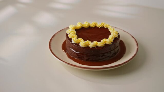 delicious chocolate Sacher cake or Prague cake on white background dessert decorated with custard cream