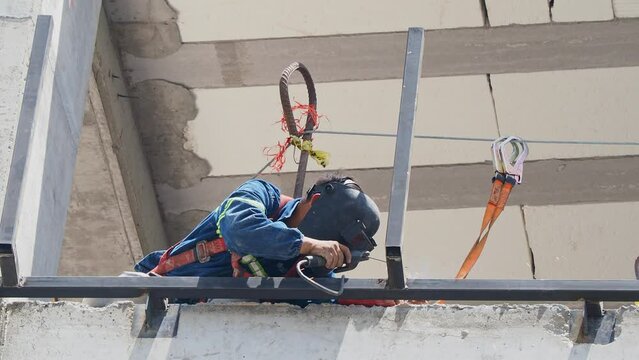 Close up shot of a worker welding in a construction site